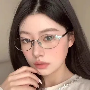 Vintage metal oval eyeglass frames for women, stylish clear lens glasses for daily wear.