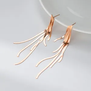 Rose gold snake bone chain long tassel earrings, elegant minimalist jewelry style for women.