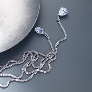 Detailed close-up of a double-layer silver teardrop necklace with sparkling zirconia pendants.