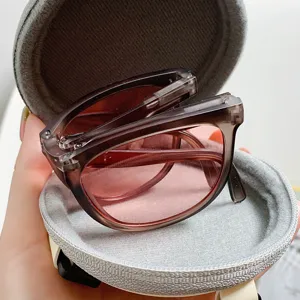 Kompakte Sonnenbrille im runden Etui, stilvolle rosa Gläser für modischen Sonnenschutz.