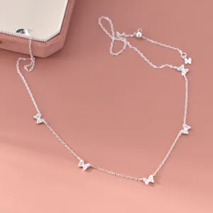 Close-up detail of the delicate S925 silver multi-butterfly necklace with shimmering zirconia stones.