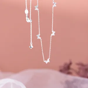 Detailed close-up of a sparkling silver butterfly pendant necklace with fine chain and zircon.