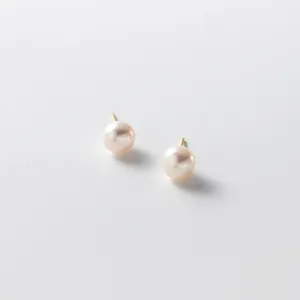 Minimalist French style pearl stud earrings detail shot, elegant and timeless jewelry.