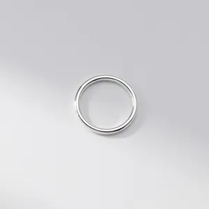 Close-up detail of smooth sterling silver plain band ring, minimalist daily fashion jewelry piece.