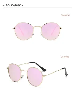 Lunettes de soleil rondes en métal doré avec verres dégradés rose, style vintage rétro.