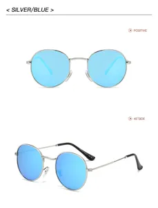 Gros plan de lunettes de soleil rondes en métal, monture argentée et verres bleus.