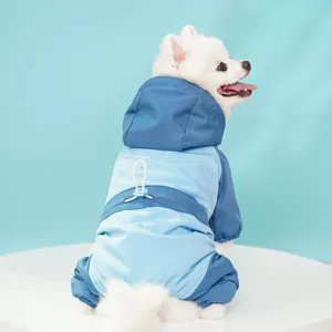 Close-up of the cute dog wearing warm blue pet ski jumpsuit with hood and drawstring.