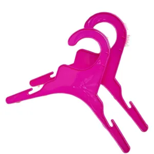 Cute pink plastic clothes hangers for small dogs and kids. Durable and lightweight design.