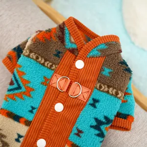 Cozy fleece pet winter clothes detail, ethnic geometric pattern dog apparel with leash ring.