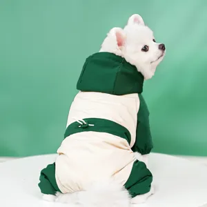 Detailed view of a green and beige pet ski jacket, showing back drawstring and four-leg design.