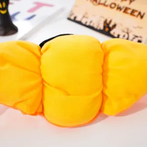 Detailed shot of the yellow plush pet pumpkin hat for Halloween, showing soft fabric and cute design.