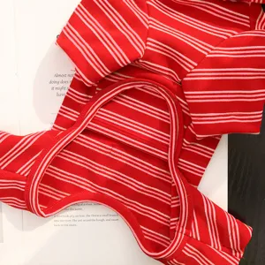 Red striped pet four-legged clothes detail view, cozy winter apparel for small dogs and cats.