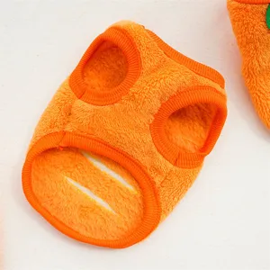 Soft orange fleece pet winter vest detail, warm puppy clothing fabric texture closeup.