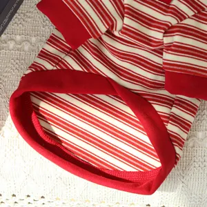 Close-up detail of red and white striped pet dog shirt collar, soft elastic knit fabric.