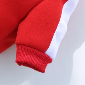 Red pet hoodie sleeve detail showing soft fabric texture and white side stripe trim.