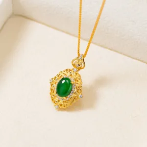 Close-up detail of an exquisite filigree oval green jade pendant necklace on a fine chain.