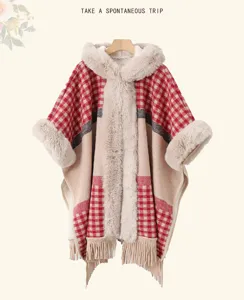 Detailed view of the thick fleece-lined plaid hooded cape, featuring cozy fur trim and tassel.