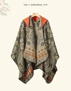 Detailed view of ethnic knit cloak featuring vibrant floral patterns and cozy hooded design.