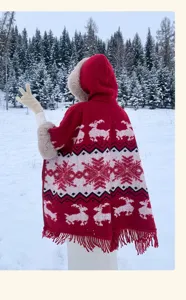 Red knitted hooded cape with deer and snowflake pattern, winter warm poncho with fringe hem.