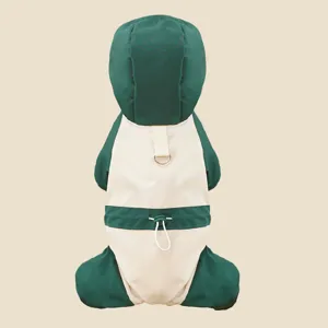 Detailed view of the pet winter snowsuit hoodie, featuring green and beige windproof blocks.