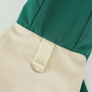 Detailed shot of pet windbreaker featuring durable fabric and a secure metal D-ring attachment.