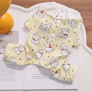 Detailed view of cute yellow striped pet dog four-legged pajamas with lace collar and bears.