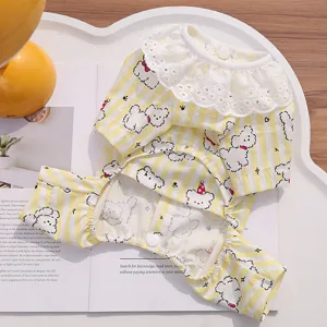 Detail view of cute yellow striped dog clothes with white lace collar and sweet cartoon bear prints.