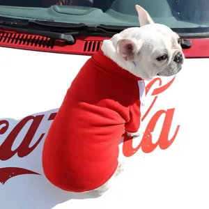 Close-up detail of a cute French Bulldog wearing a cozy red dog hoodie for autumn and winter warmth.
