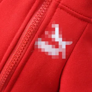 Red pet dog hoodie detail winter warm pet apparel with zipper and chest logo patch design.