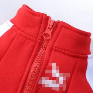 Red pet dog hoodie detail close-up, warm fleece zipper sweater apparel for small dogs and cats.