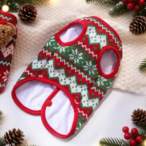 Close-up view of a festive red and green knitted pet Christmas vest with geometric patterns.