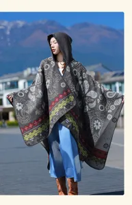 Ethnic style hooded knitted cape for women, cozy winter shawl and stylish autumn outerwear.