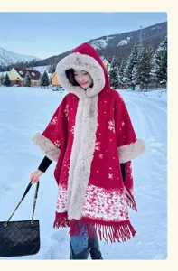 Detailed view of the winter faux fur hooded cape, cozy warm red poncho with snowflake pattern.