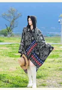 Detailed view of the ethnic knit hooded cloak, showing intricate pattern and texture.