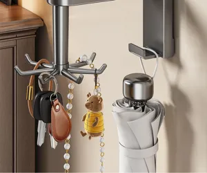 Wall-mounted rotating key hook organizer for entryway, durable metal multi-claw rack for home.