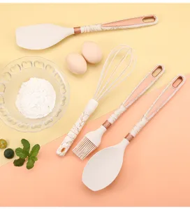 Close up detail view of premium silicone kitchen utensils featuring elegant marble design handles