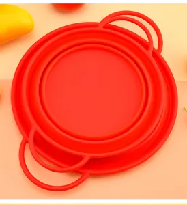 Red collapsible silicone colander basket for kitchen vegetable draining and steaming.