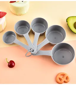 Plastic measuring cups and spoons set with clear capacity markings for baking kitchen tools.