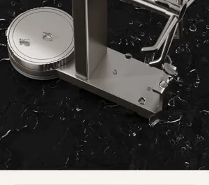 Detailed shot of a metallic rotating key holder and entryway organizer hook on a wet surface.