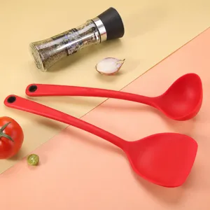 Red silicone kitchen spatula and soup ladle set, heat resistant non-stick cookware tools.