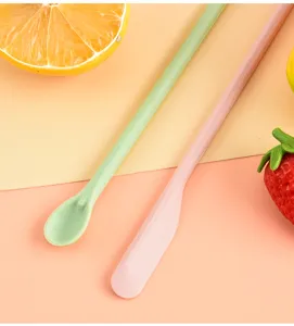 Detail view of mini silicone spatula, dual-ended makeup scraping tool and jam spoon.