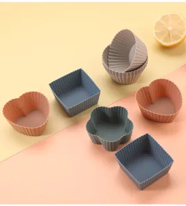 Silicone baking mold set featuring heart, square, flower and round shapes for tasty muffins.