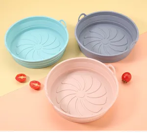 Detailed view of collapsible silicone air fryer pot, round baking tray in multiple colors.