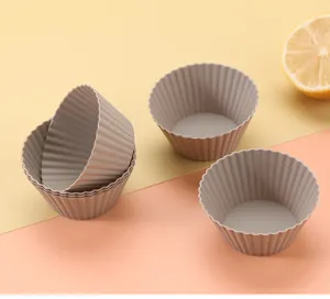 Silicone muffin cup detail view, flexible grey baking mold texture closeup shot for kitchen.