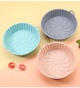 Silicone air fryer pot detail view showing round baking liner with convenient handles and textured base.