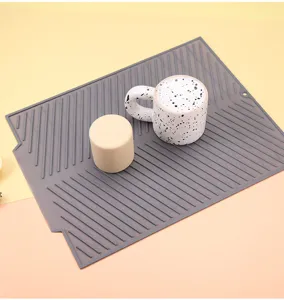 Silicone drying mat for kitchen sink, heat resistant dish drainer pad for counter and tableware.
