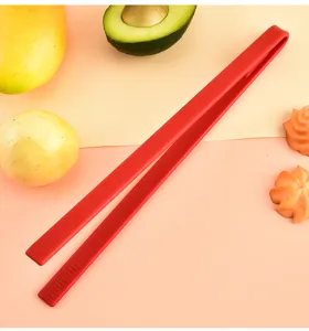 Detailed view of red silicone food tong, essential kitchen cooking tool with non-slip grip.