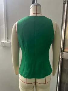 Back detail view of a stylish green sleeveless suit vest, elegant slim fit office wear.
