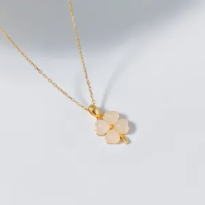 Detailed close-up view of the delicate white jade four-leaf clover pendant necklace chain.