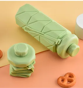 Green collapsible silicone water bottle detail showing folding structure and texture design.